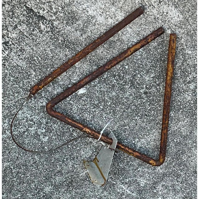 This vintage triangle dinner bell is fashioned from a single length of heavy iron rod bent into an open triangular form,...