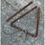 This vintage triangle dinner bell is fashioned from a single length of heavy iron rod bent into an open triangular form,...