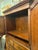This is an antique linen press circa 19th century. This is a two piece English design. It has an upper cabinet with a lock...