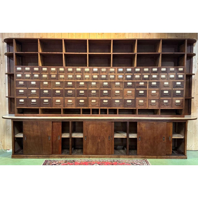 Large 1950s seed cabinet made of elm, chestnut, fir, and oak. Formica top on hardboard and original plywood sides. Height:...