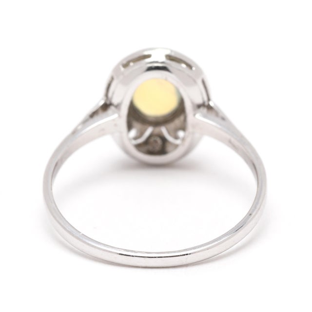 Stones: opal oval cab diamond single cut 1.3-1.5 mm .08 ctw GH color/ VS2 clarity Ring Size 5.5 Rise Off Of Finger: 4.7 mm...