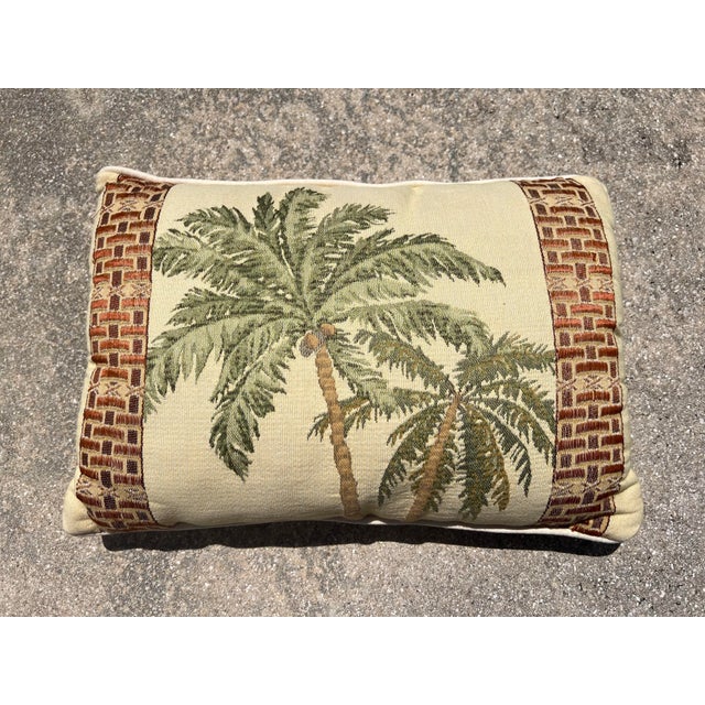 Vintage woven tapestry throw pillow featuring a tropical palm tree motif framed by patterned borders. Features a central...