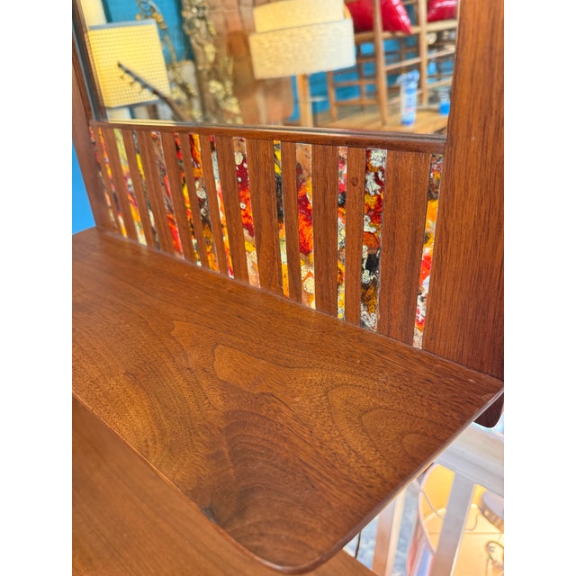 Mid century mirror with built-in shelf designed and made by ceramic artist Harris Strong. Functional art that really calls...