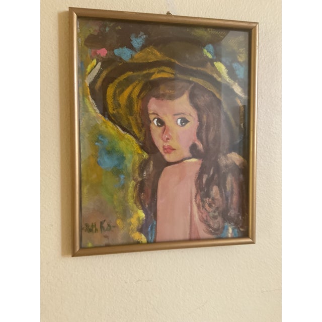 A charming mid‑century oil painting depicting a young girl with expressive eyes and flowing brown hair, wearing a...