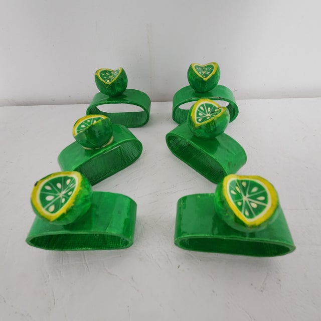 A playful set of six vintage hand-painted paper mâché napkin rings featuring dimensional lime slice toppers. Lightweight...