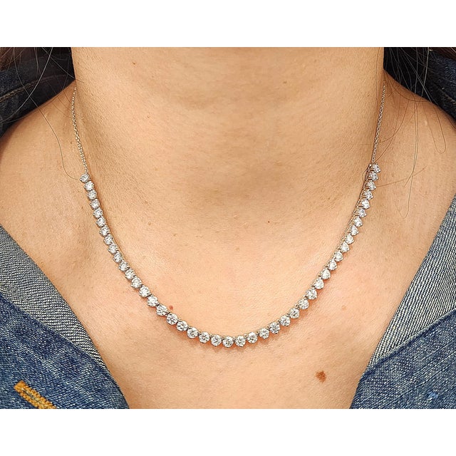 A stunning natural diamond tennis necklace featuring 44 round brilliant-cut diamonds totaling 3.87 ct. Crafted in 14k...