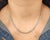 A stunning natural diamond tennis necklace featuring 44 round brilliant-cut diamonds totaling 3.87 ct. Crafted in 14k...