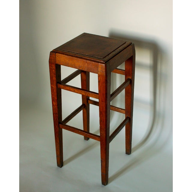 A square-section molded oak side table, late 19th/early 20th century. Probably originally a high stool. The stepped top...
