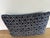 Striking Hmong-inspired tribal textile pillow in deep indigo with a crisp ivory diamond lattice motif. The textile has...