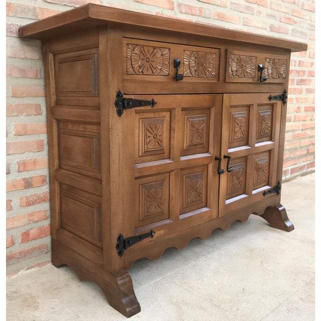 About From Northern Spain, constructed of solid walnut, the rectangular top with molded edge atop a conforming case...