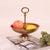 Crafted from brass, this fruit tray features a ring handle and textured surface, boasting exquisite texture and a...
