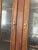 A handsome two-piece step-back hutch in dark-stained pine with rich wood grain throughout. The upper section features two...