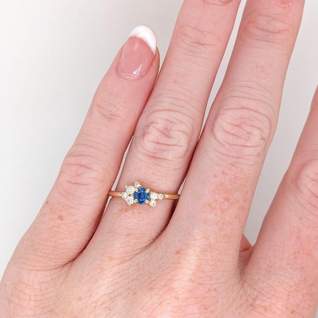 This simple and sleek blue sapphire ring is made for the minimalist in your life! With asymmetrical diamond accents around...