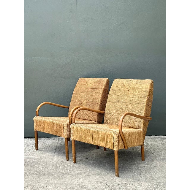 This pair of vintage Japanese lounge chairs pairs minimalist design with a warm, organic material palette of hand-turned...