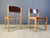 Sven Markelius style two-toned stacking chairs with simple modernist birch frames and brown seats and backs. The chairs...