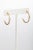 Pair of unusual 18K gold hoops with a textured design. Diameter is 1 inch. Gold post with push for pierced ears. The fine...
