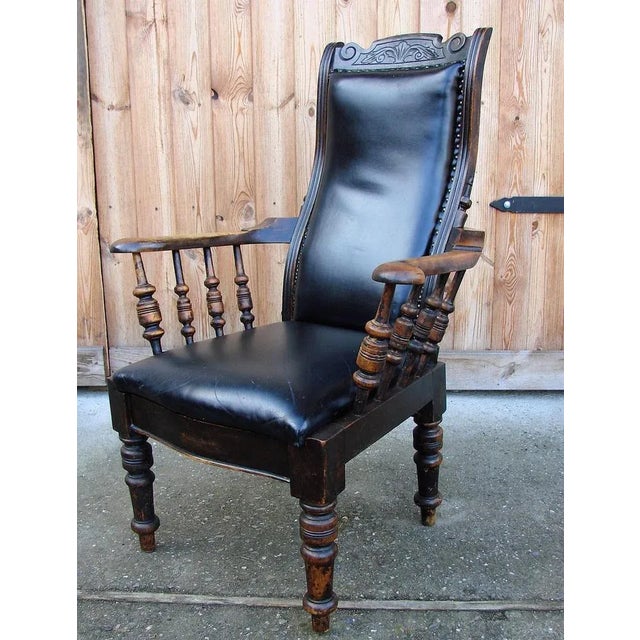 Oak armchair from the 19th century. It is preserved in good condition, the upholstery is made of black natural leather....