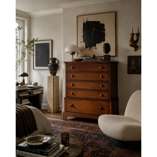 This vintage five-drawer dresser features a clean transitional silhouette with softly rounded edges, paneled sides, and...
