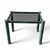 A compact 1980s postmodern side table with a smoked glass top and sculptural metal frame finished in a mottled green-gray...