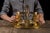 A finely detailed brass flush mount fixture with four lights radiating from a domed base. The design incorporates floral...