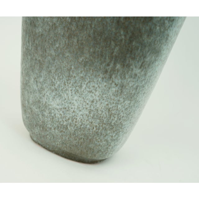 A beautifully shaped and elegant ceramic vase with a semi-matte glaze in different shades of gray and brown, designed by...