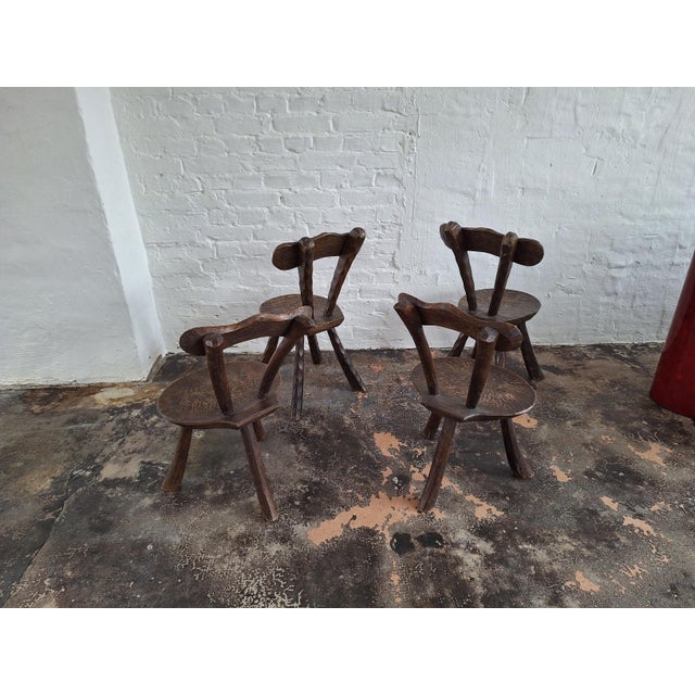 Set of 4 hand-crafted Brutalist elm chairs in the style of Alexandre Noll, France 1950s. 2 of the chairs are tripod...