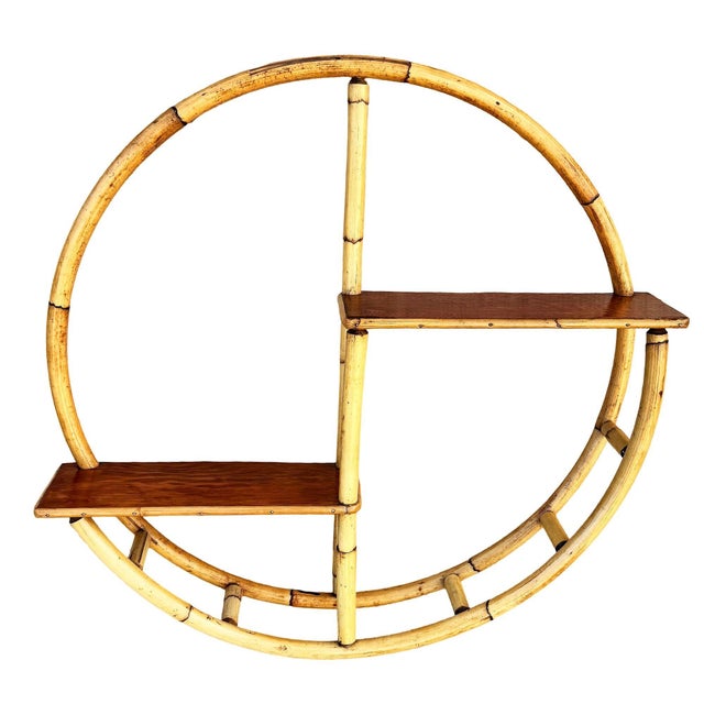 Beautifully restored Mid-century era circular "Skeleton" shelf crafted from a steam bent rattan frame with a central...
