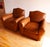 Fantastic pair of French Art Deco style club chairs from the 21st C. featuring beautiful brown-cognac leather and charming...