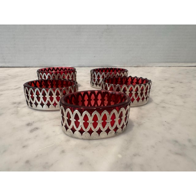 A set of five lovely salts in cranberry glass encased in sterling silver. Beautiful condition.