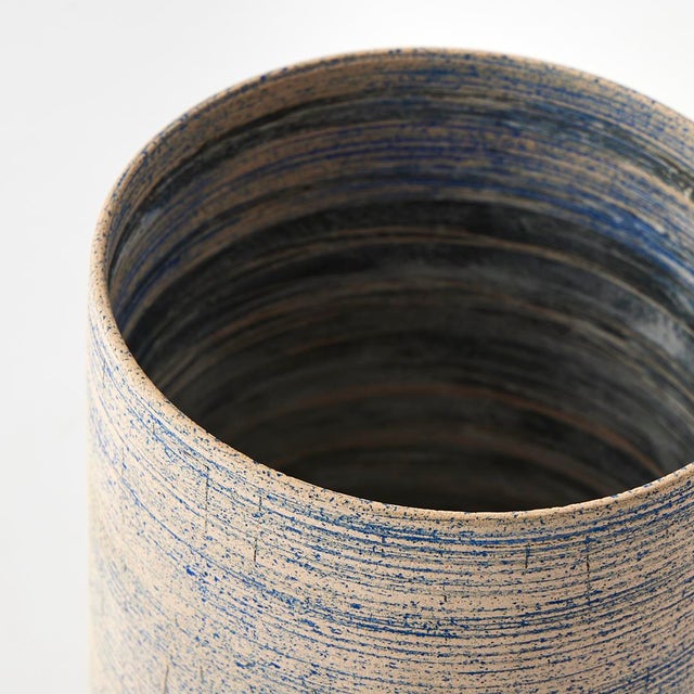 - A minimal form with an intriguing texture, this ceramic vessel doubles as sculpture. We love its palette of blue and...