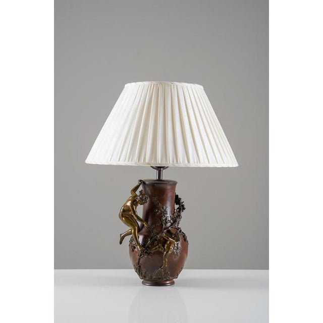 Exceptional bronze table lamp originally crafted as a vase by french artist eugène provost (1836–1885). The vessel...