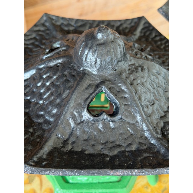 A charming pair of vintage cast iron pagoda-style lanterns, painted in a bold green with black pagoda tops. Heavy,...