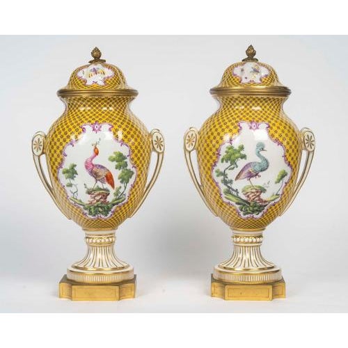 This magnificent pair of covered vases from the early twentieth century is a refined example of the louis xvi style,...