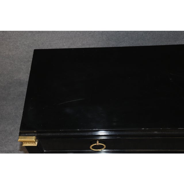 This exceptionally sophisticated black lacquer and brass-mounted commode by De Coene Frères is a striking example of the...