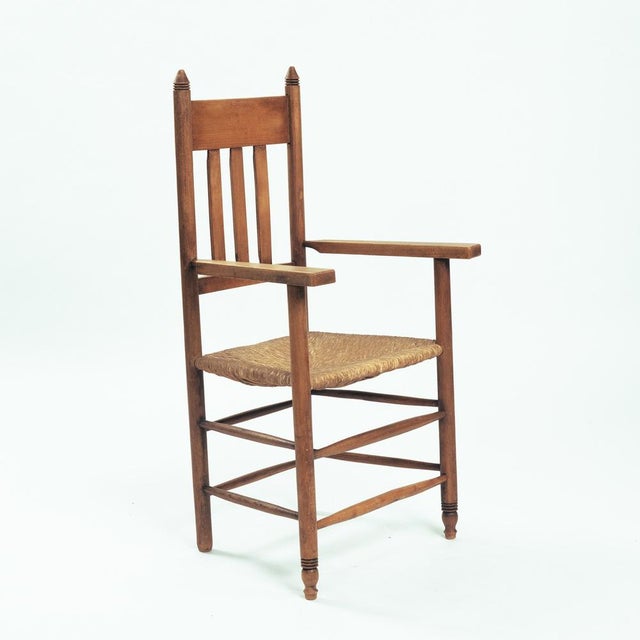 Oak armchair in Amsterdam school style, with woven straw seat, 1930 In good condition. measurements: height 110cm x wide...