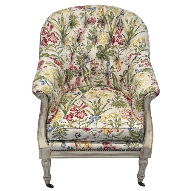 Elegant traditional armchair upholstered in a vibrant botanical floral fabric featuring labeled florals and butterflies....