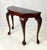 An elegant Queen Anne / Chippendale style demilune console table crafted from warm cherry wood. This half-round wall table...
