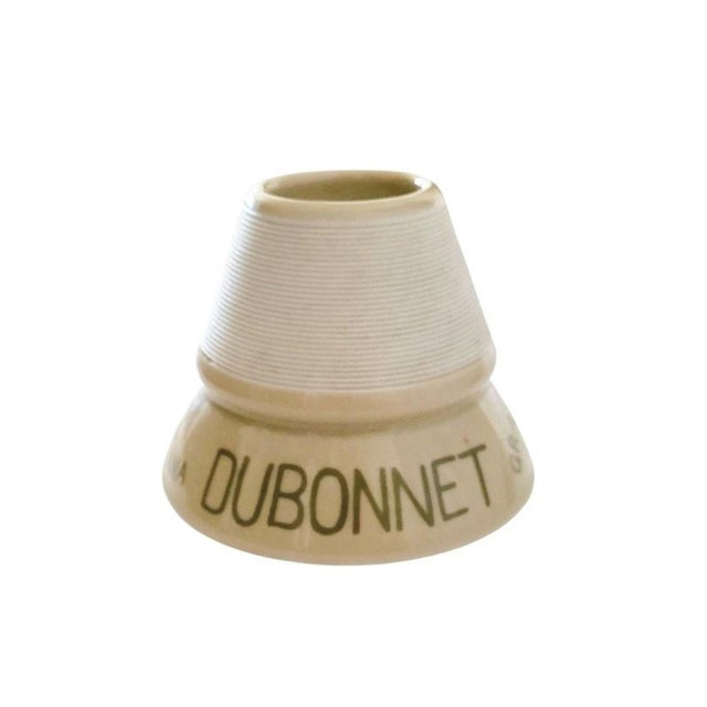This Dubonnet Vin Au Quinquina ceramic match striker, or pyrogene, is a French advertising piece dating to the 1950s. The...