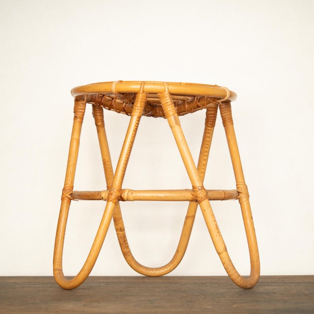 A rattan and bamboo stool from the 1950s. In good overall condition with normal signs of use and age. This piece is...