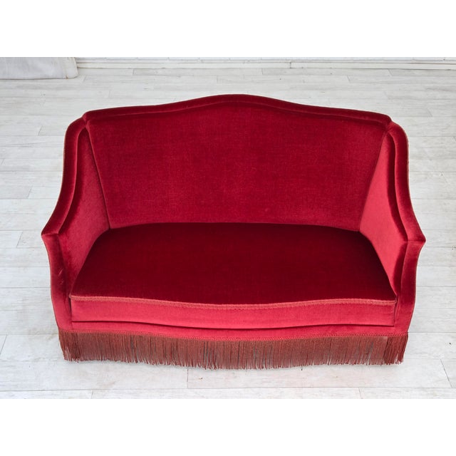 1970s, Danish 2-seater sofa. Original red furniture velour, ash wood legs, springs in the seat. Original very good...