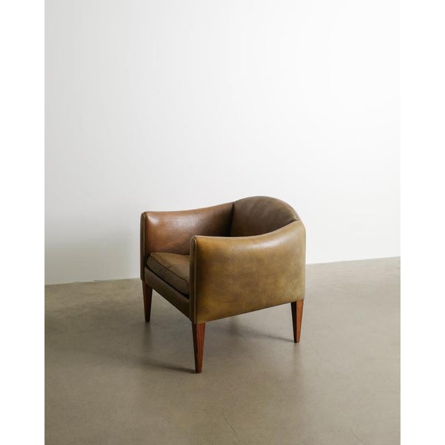 A rare danish mid century "v12" armchair in thick original olive brown / green leather with beautiful matching rosewood...