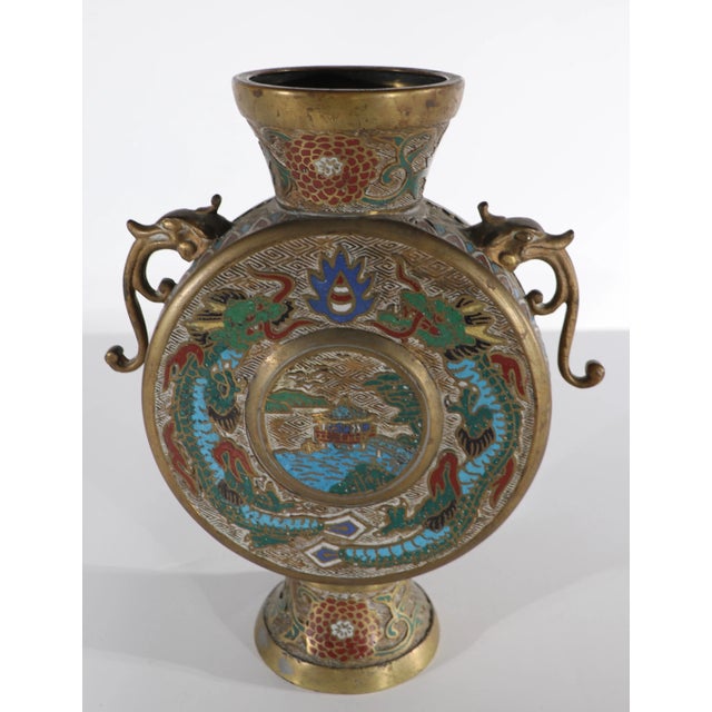 Vintage Chinese vase in brass, with traditional enameled pictorial motif. The vase has a disk form body, with brass...