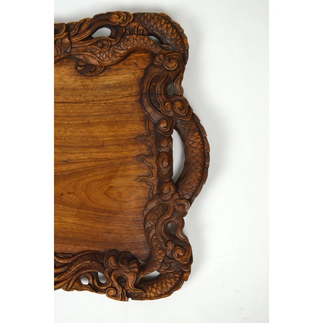 Superb Indochinese table / serving tray in carved wood. Very elaborate sculpture with a mythological theme (dragons). Nice...