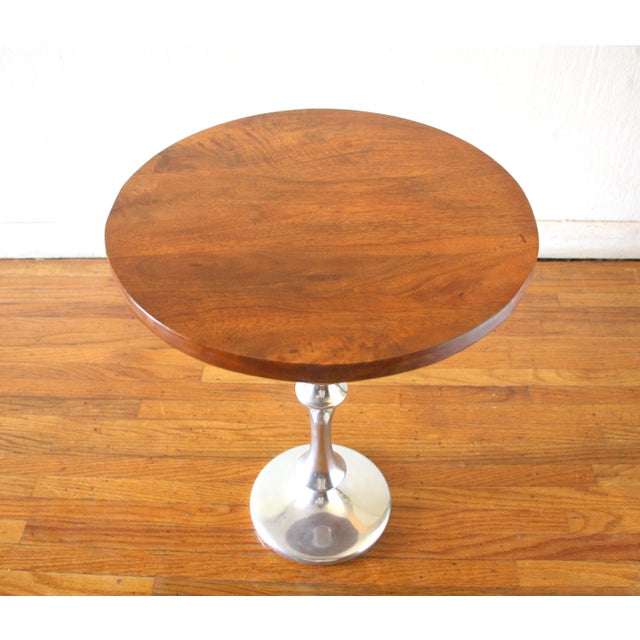 This is a mid century modern martini table with a beautiful solid wood top and sleek chrome base. Dimensions: 16" diameter...