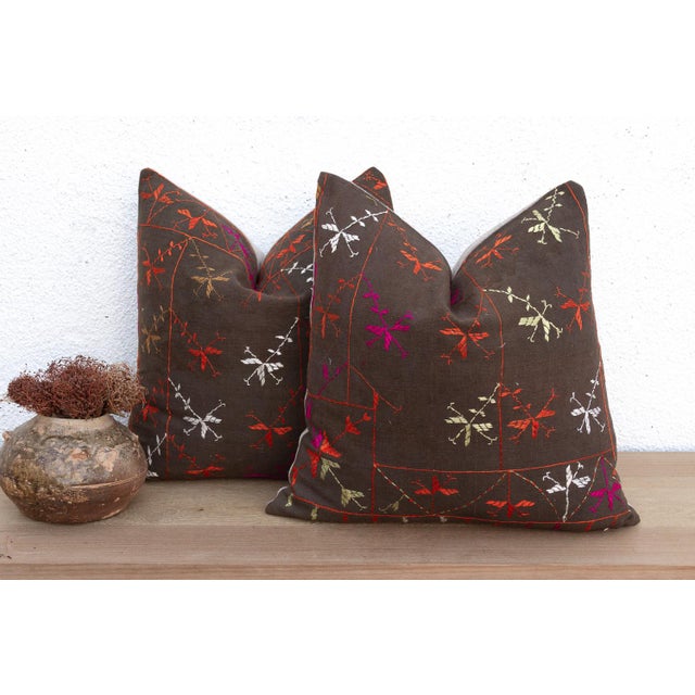 This curated set of two 18-inch square pillows offers a rare opportunity for symmetry, handcrafted from the same Antique...