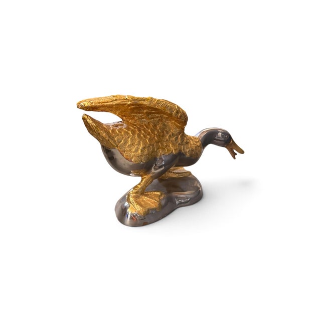 Striking vintage decorative duck sculpture featuring a dramatic combination of richly textured gold-tone and polished...