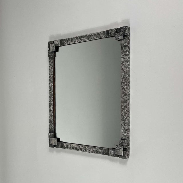 This rare wall mirror was designed and manufactured in Sweden in the 1940s. It features a tin frame and mirror glass....