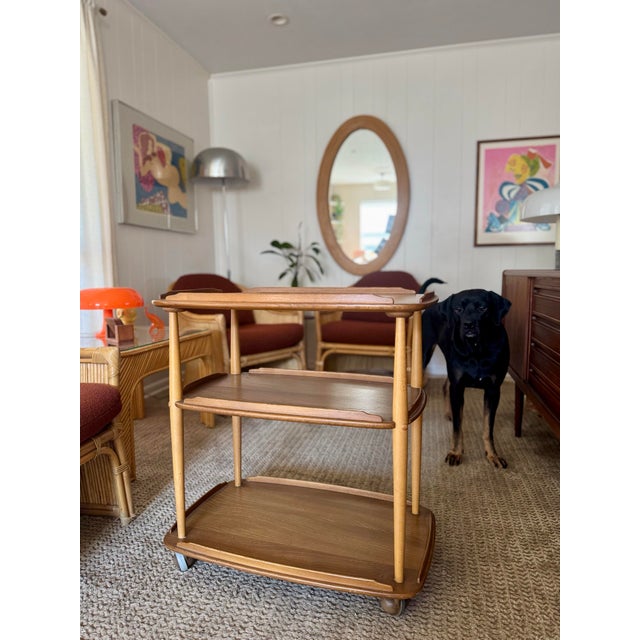 A mid century modern elm and beech bar cart by Ercol & designed by Lucian Ercolani, circa 1960s. Featuring three solid elm...