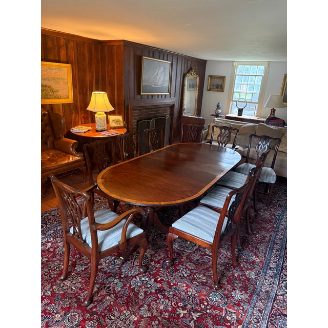 Exceptional complete formal dining suite in the Regency manner, offered as a matched set of table and ten chairs. The...