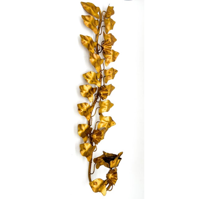 Striking mid-century Italian gilt metal wall sconce with an elongated ivy vine form. The flowing vertical silhouette gives...